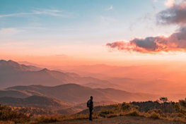 man standing on hill digital wallpaper